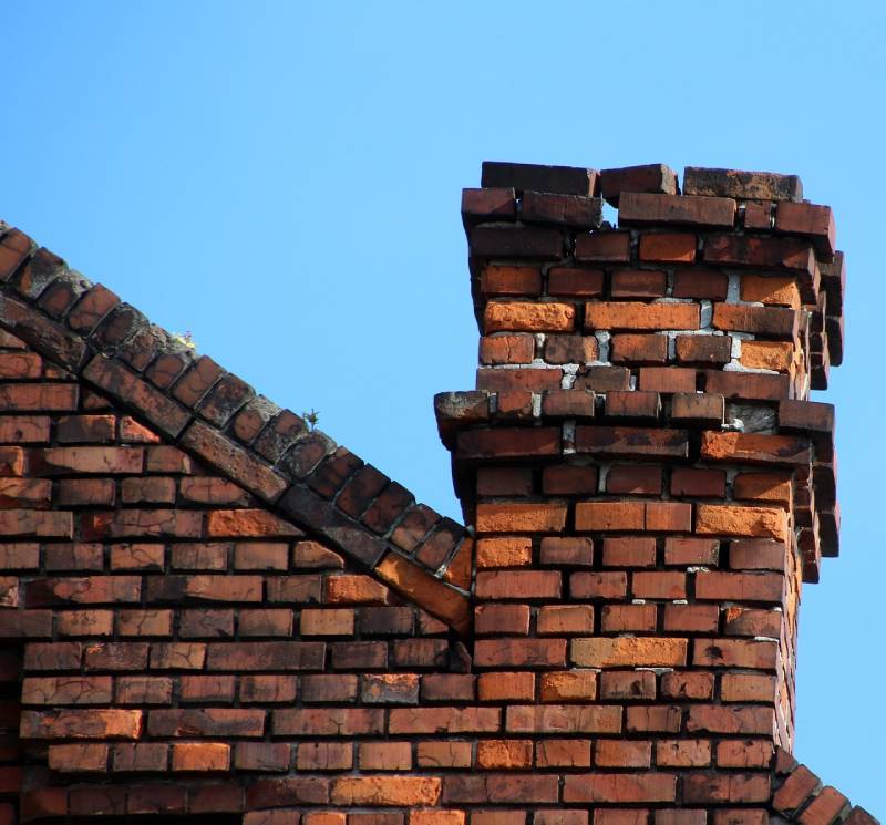 Signs Your Countryside Home Needs a Chimney Inspection Damaged chimney on an Countryside home showing cracks and missing mortar